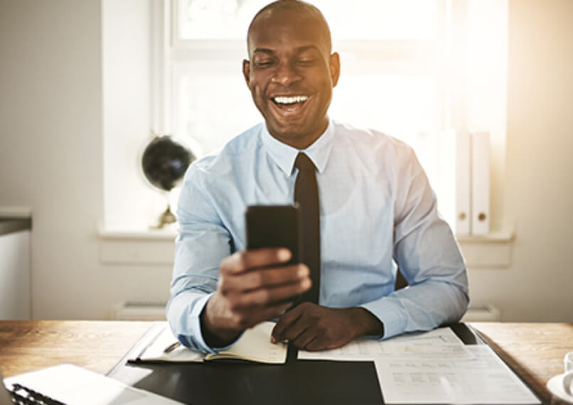 Man smiling at phone