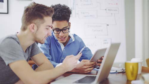 Two university students have a study session using screen sharing software on multiple devices