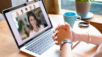 Woman video conferencing on laptop
