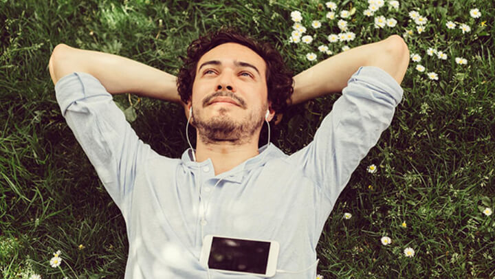 Man on the floor with his headphones on