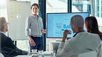 Business woman presents a screen sharing recording in a modern boardroom